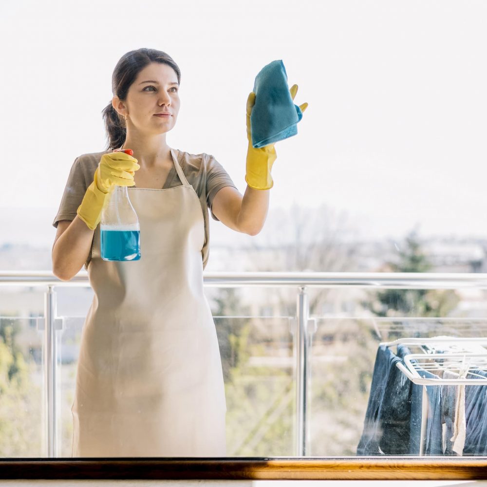 front-view-woman-cleaning-window (1)
